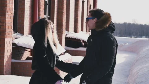 Girl is pushing the guy into the snow Stock Footage 80532836
