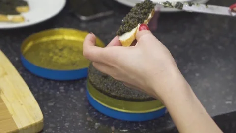 Girl puts caviar on white bread Stock Footage