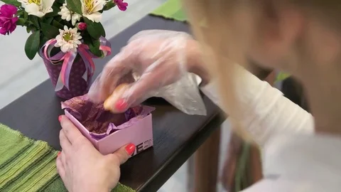 Girl puts the cookie in a box Stock Footage 77990642