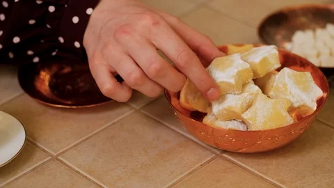 Girl puts in a copper plate Eastern sweets kurabiye 스톡 동영상 123786232