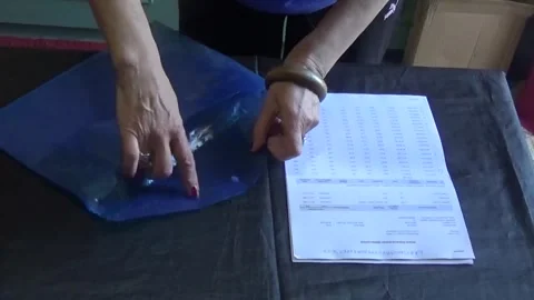 The girl puts the documents back into the folder Video stock 308368108