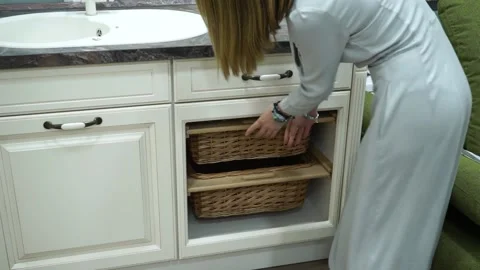 The girl puts forward baskets. kitchen interier Video stock 229843735