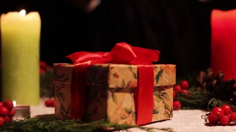 The girl puts the gift on the table Stock Footage 83416799