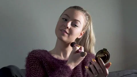 Girl puts make up on with brush Video stock 146448883