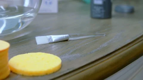 Girl puts makeup brush on the table Stock Footage 150704786