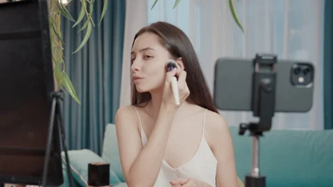 Girl puts makeup on face in front of Stock Video Pond5