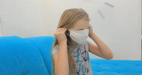 Girl puts on a mask Stock Footage 145448264