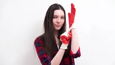 Girl puts on red construction gloves Stock Footage 201610323