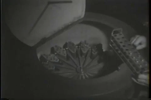Girl puts test tube samples in the centrifuge and switches it on - 1950 Stock Footage 94067582