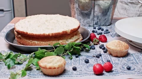Girl is putting cream on shortcake Stock Footage