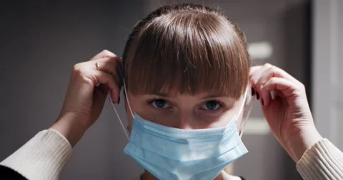 Girl Putting On Face Medical Mask Stock Footage