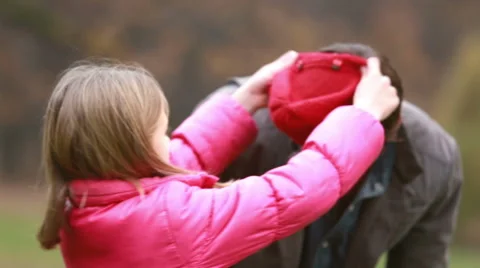 Girl putting her cap on dad's head Stock Footage 59554651