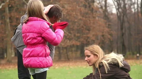 Girl putting her red cap on father's head Stock Footage 59554186