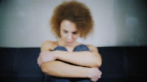 The girl raises the head from knees and the evil looks in the camera Stock Footage 59238122