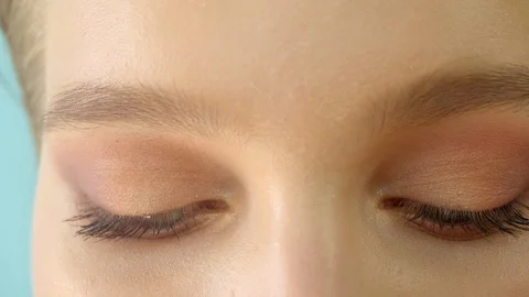 Girl is reading and looking at the camera. Very close-up. Video stock 114499008