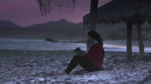 Girl reading on the beach 2 Stock Footage 10817875