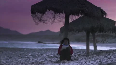 Girl reading on the beach Stock Footage 10817834
