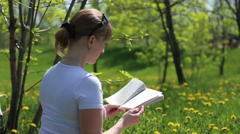 Girl reading a book Stock Footage 62908177