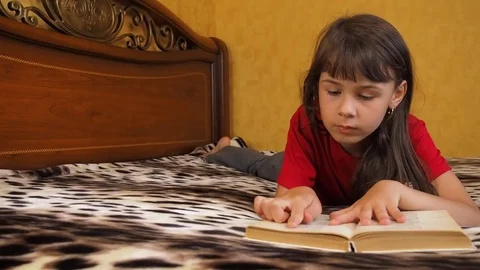 The girl is reading a book. Stock Footage