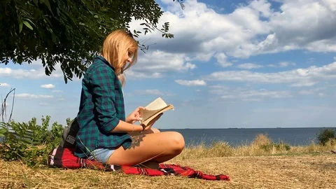 The girl is reading a book Stock Footage 81609652