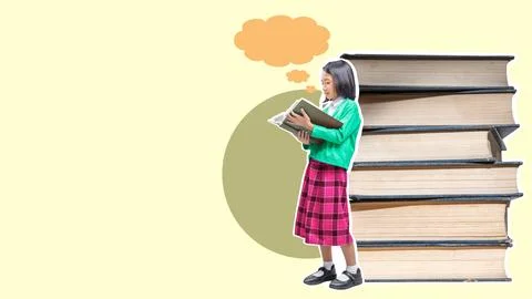A girl is reading a book in front of a stack of books Stock Photos