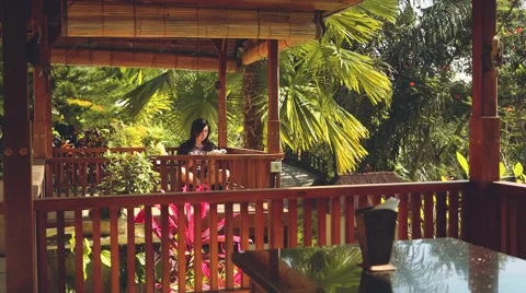 Girl reading book in gazebo Stock Footage