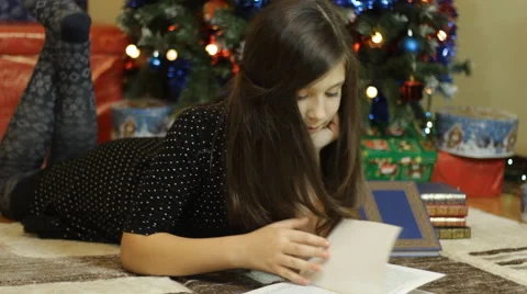 Girl reading on Christmas Stock Footage