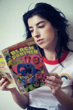 Girl reading a comic Stock Photos