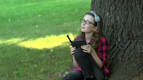 A girl reading an electronic book Stock Footage 44116337