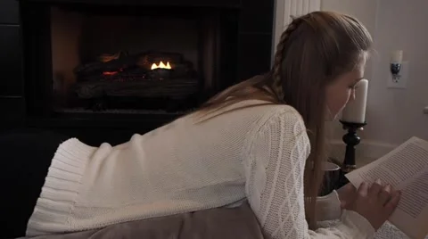 GIrl reading with a fire Stock Footage 45523550