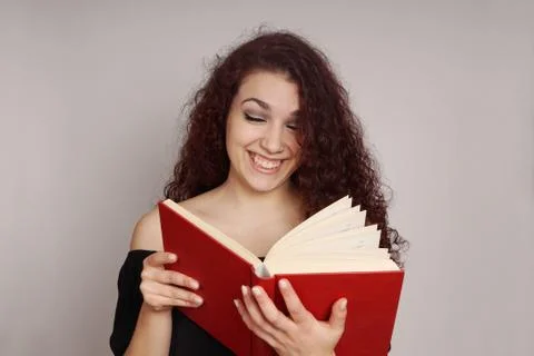 Girl reading a funny book Stock Photos