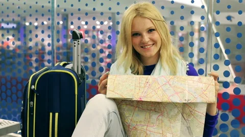 Girl reading map and smiling to the camera on the station Stock-Footage 41249953
