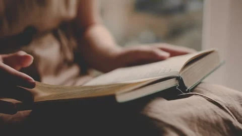 Girl reads an ancient book at home. female hands turning pages Video stock 246084553