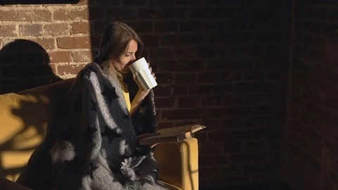 Girl Reads Book While Having Tea Видео 80678479