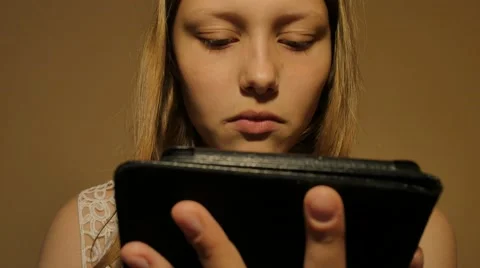 Girl reads e-book e-reader. 4K UHD Stock Footage 65160297