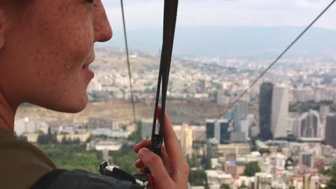 A girl ready to go down on a zip line to the lower base brimming with emotions Stock Footage 248530316