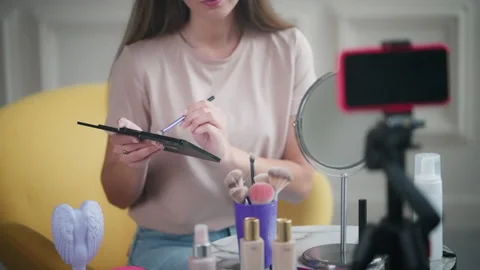 Girl recording video with make-up tutorial for beauty vlog 動画素材 224527387