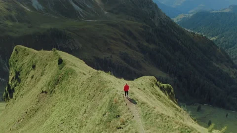 Girl in a red jacket standing on a cliff in the picturesque Dolomites. Stock Footage 149765189