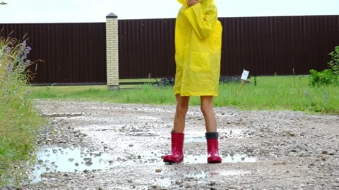 A girl in red rubber boots and a yellow Stock Video Pond5