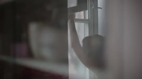 The girl in the reflection of the glass smokes near the window Stock Footage 59798355