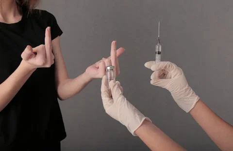 The girl refuses the proposed vaccine. shows the fuck. covid. virus. graft Photos