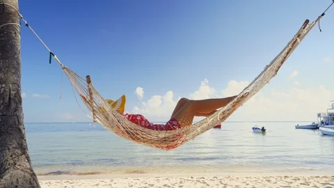 Summer relaxation. Full length top view of attractive young woman in  swimwear keeping hands behind head while lying down in hammock outdoors  13450494 Stock Photo at Vecteezy