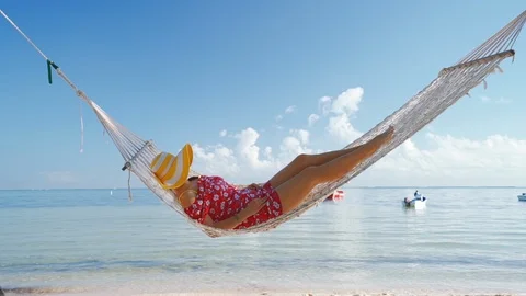 Summer relaxation. Full length top view of attractive young woman in  swimwear keeping hands behind head while lying down in hammock outdoors  13450494 Stock Photo at Vecteezy