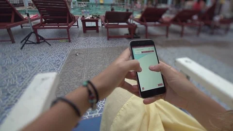 Girl Relaxing by the Pool Using a Mapping App on Iphone 6 Stock Footage 79161174