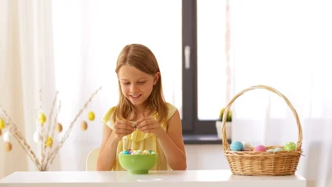 Girl removing wrapper of chocolate easter egg Stock Footage 95114515