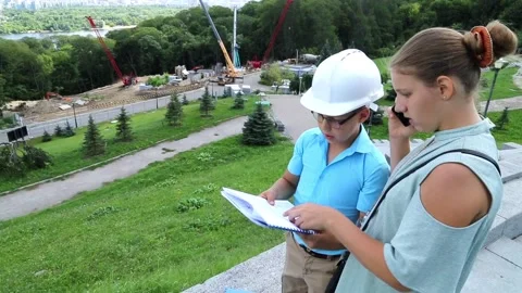 The girl reports by phone on the progress of construction Stock Footage 97266444