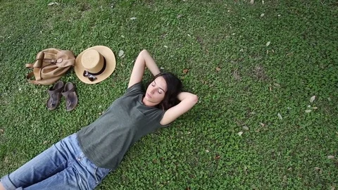Girl Resting lying on the grass Stock Footage