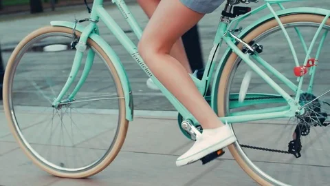 Girl riding bike in a dress Stock Footage