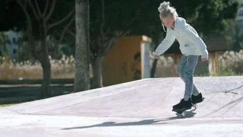 Girl riding on waveboard with two wheels, modern street skate sports of Stock-Footage 229657697