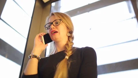The girl rises in the elevator and talks on the phone. Stock Footage 82800700